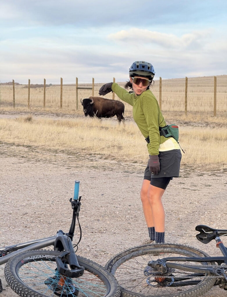 bike tour leader posing next to a bison