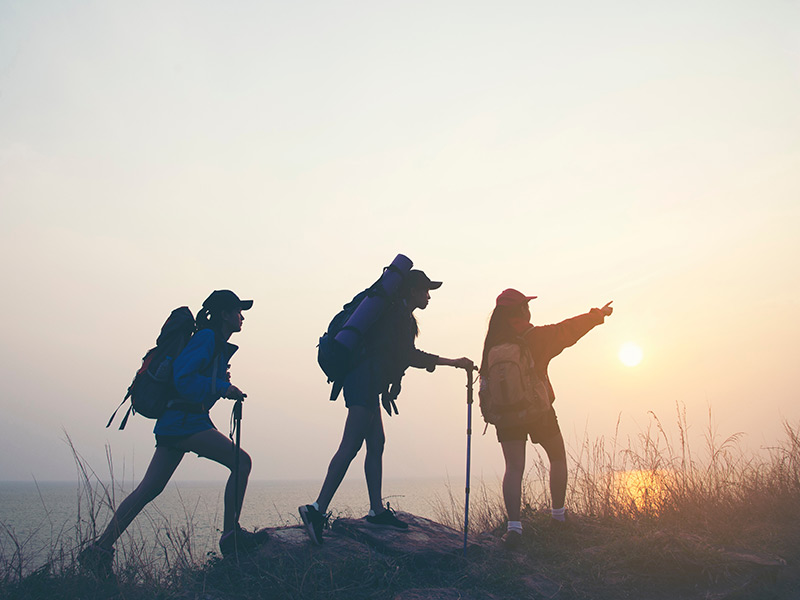 teenagers hiking up a small mountain