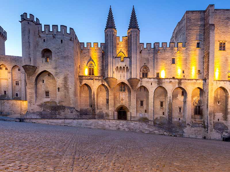 Avignon, The central facade of the papal palace at dawn.