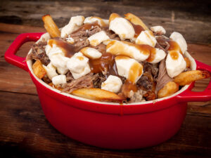 duck confit poutine dish on wood table