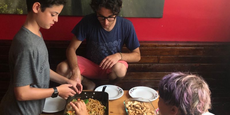 teen bike tourists eating lunch
